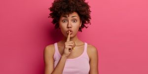 surprised-african-american-woman-asks-keep-quiet-about-her-secret_273609-41005